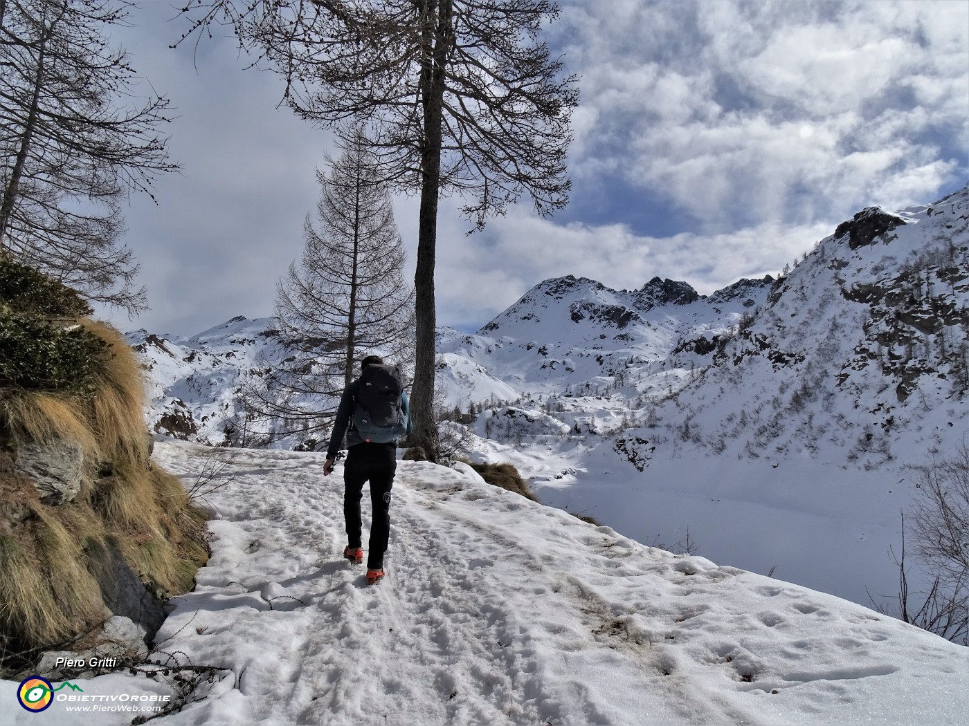 30 Risaliti sull'alto della diga proseguiamo con accanto l'invaso vuoto ricoperto di neve .JPG
